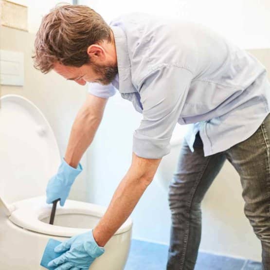 men_cleaning_toilet_bowl.jpeg