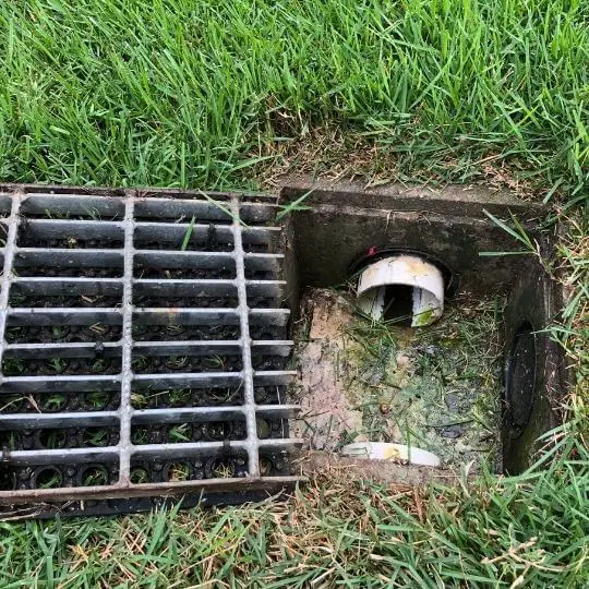 french_drain_with_metal_grate.jpeg