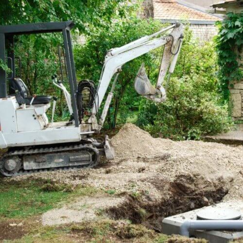 small_excavator_digging_ground.jpeg