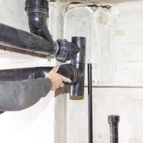 plumber_fixing_broken_toilet_drainage_pipe.jpeg