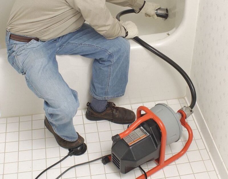 plumber_with_drain_auger.jpeg