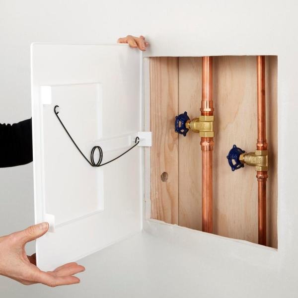 heating_pipes_behind_dry_wall_access_doors.jpeg