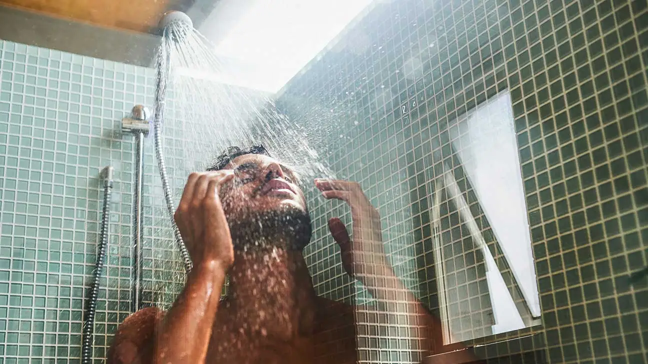 men_using_hot_water_on_shower.webp